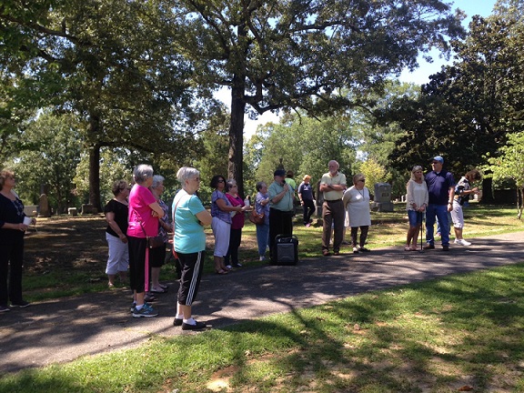 Photo of group of people in old cemetery