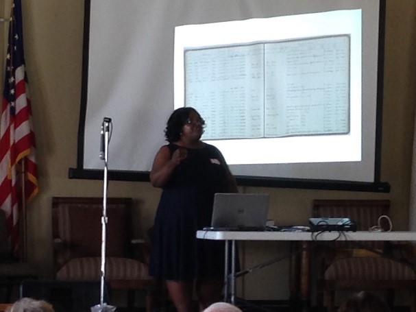 Lady addressing genealogy group about research.